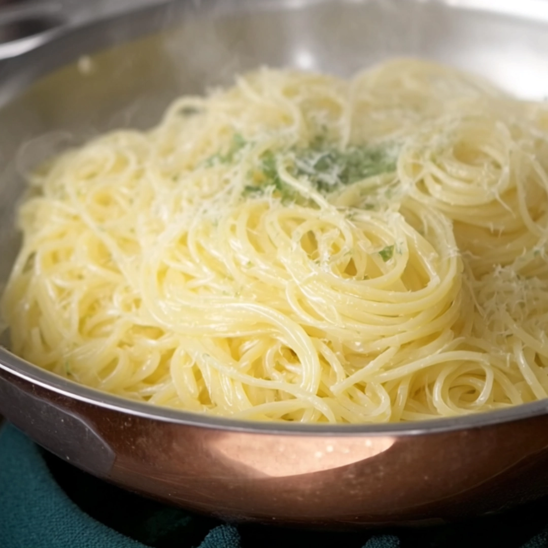 cook-spaghetti-lemon-pasta Alt Text: Cooking spaghetti al dente for lemon parmesan pasta