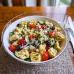 Greek tortellini pasta salad with fresh vegetables and feta