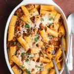 Close-up of baked rigatoni with ground beef and melted mozzarella cheese