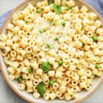 Creamy Italian ditalini pasta recipe with peas and basil garnish
