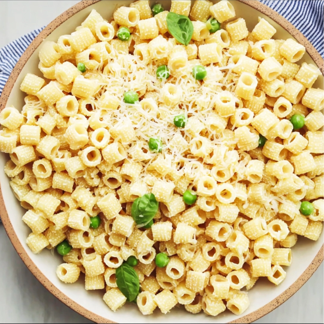 Creamy Italian ditalini pasta recipe with peas and basil garnish