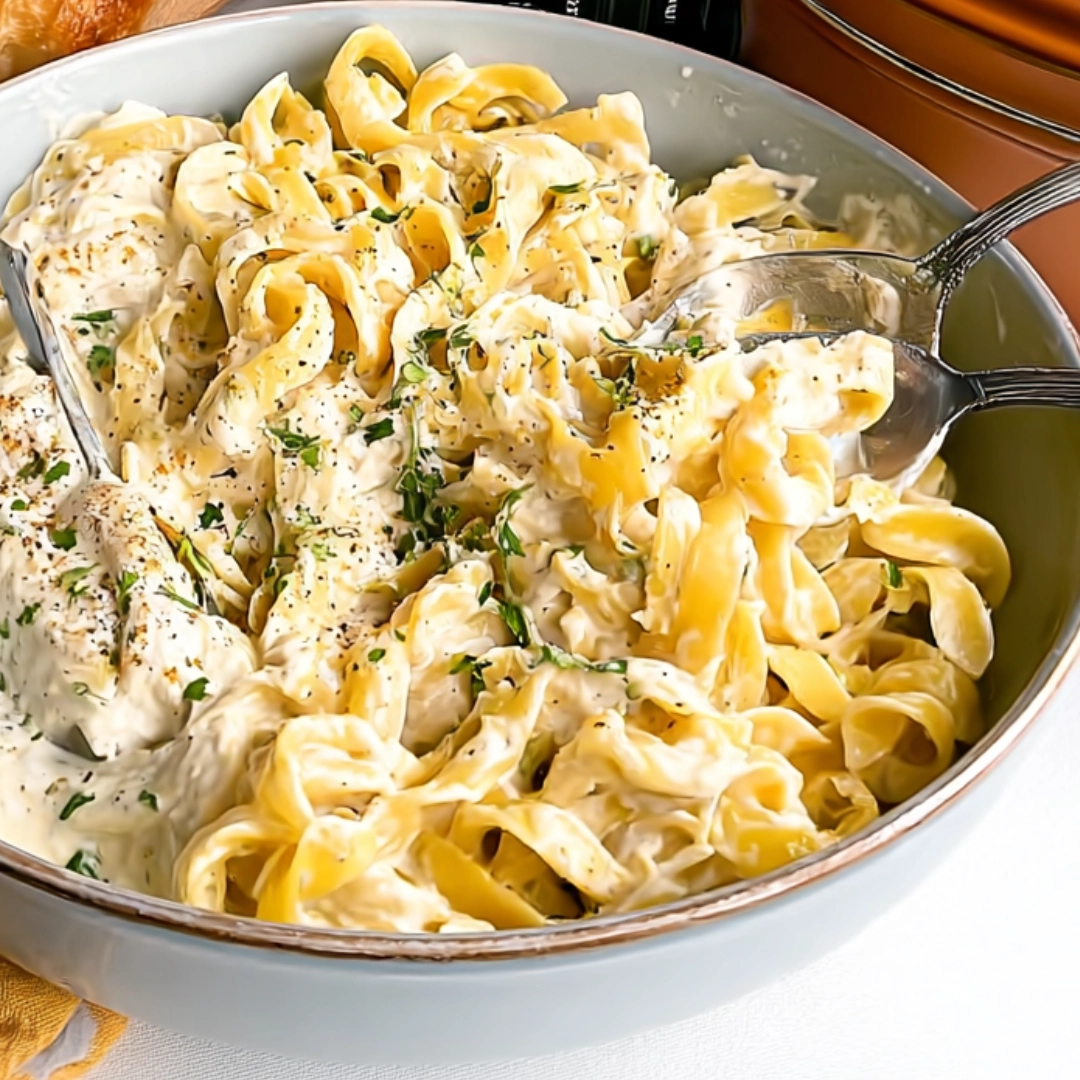philadelphia-cream-cheese-pasta-bowl Bowl of philadelphia cream cheese pasta with herbs and cracked black pepper on top