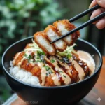 A beautifully plated and sliced Homemade Japanese Katsu Bowls with Tonkatsu Sauce, showing the golden-brown crust.