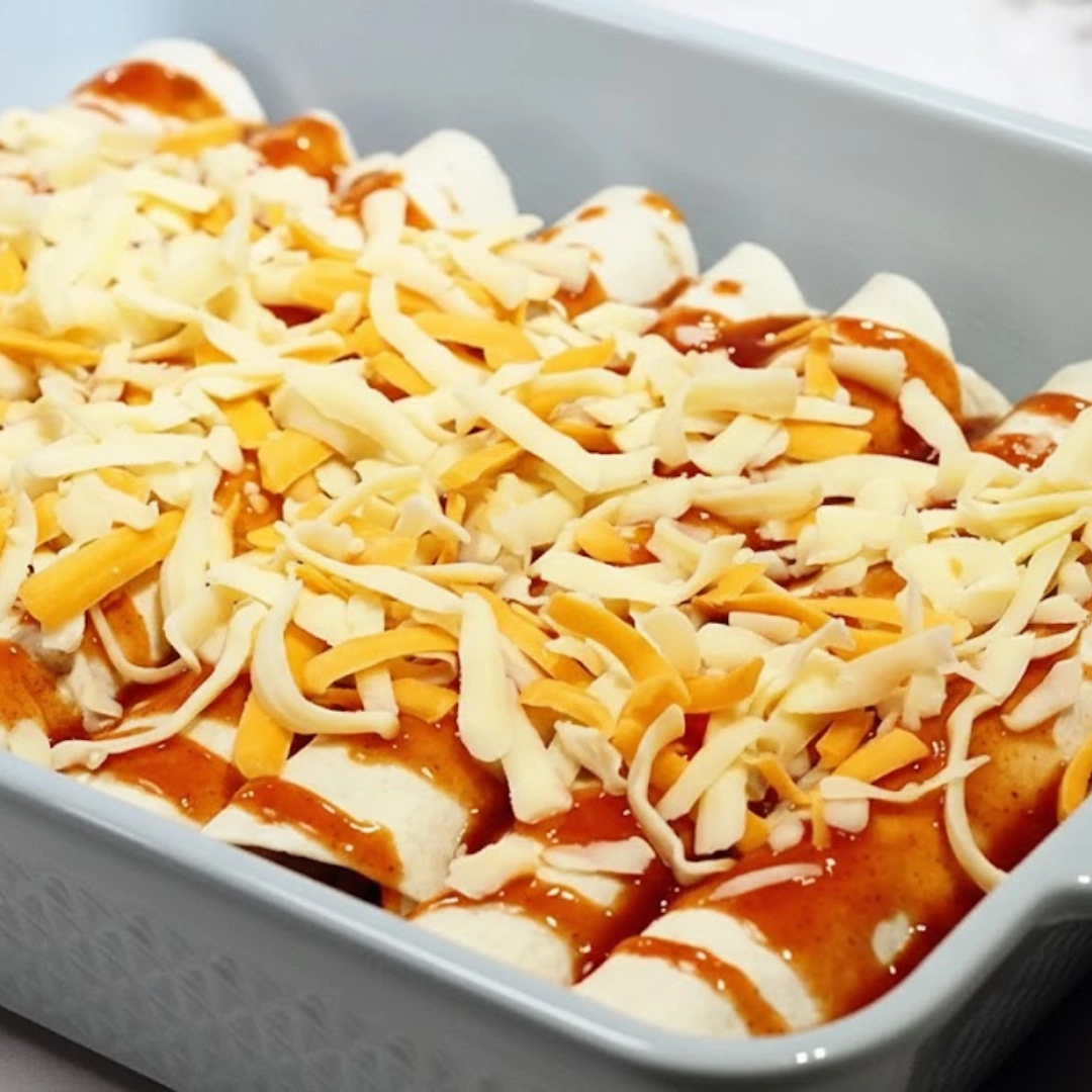sy, tested 5 Ingredient Beef Enchiladas baked in a casserole dish with melted cheese and red sauce. sy, tested 5 Ingredient Beef Enchiladas baked in a casserole dish with melted cheese and red sauce.