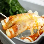 sy, tested 5 Ingredient Beef Enchiladas baked in a casserole dish with melted cheese and red sauce.