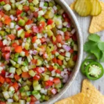Large bowl of fresh pickle de gallo recipe with tortilla chips for dipping.