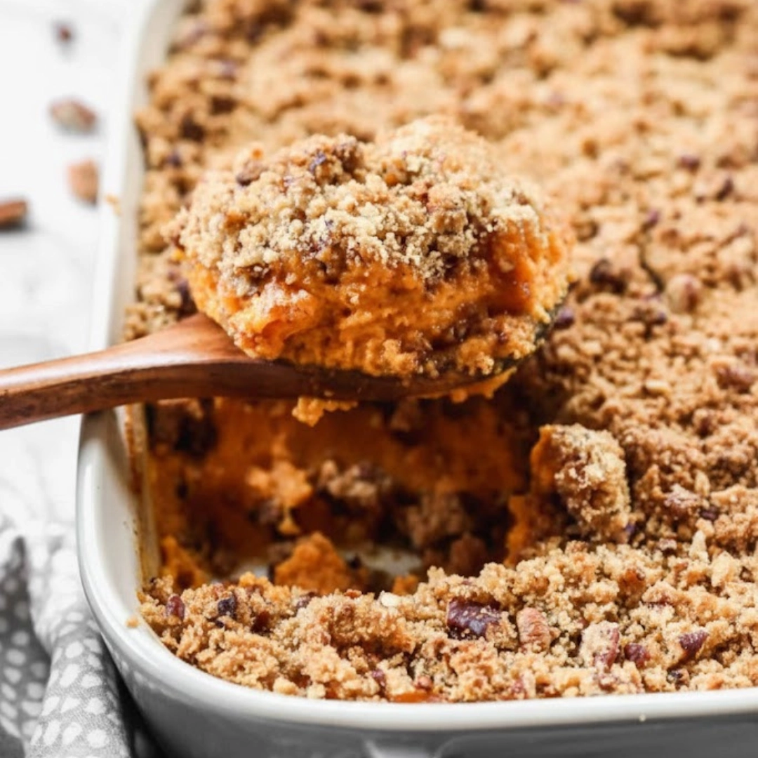 Fluffy sweet potato casserole topped with a golden brown pecan streusel
