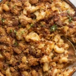 A close-up of baked French Onion Mac and Cheese with a golden panko crust.